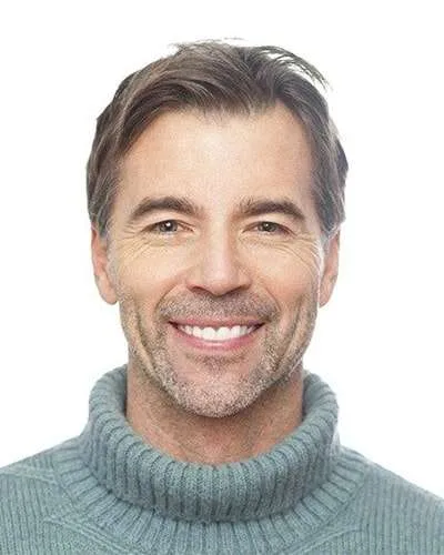 man in turtle neck smiling
