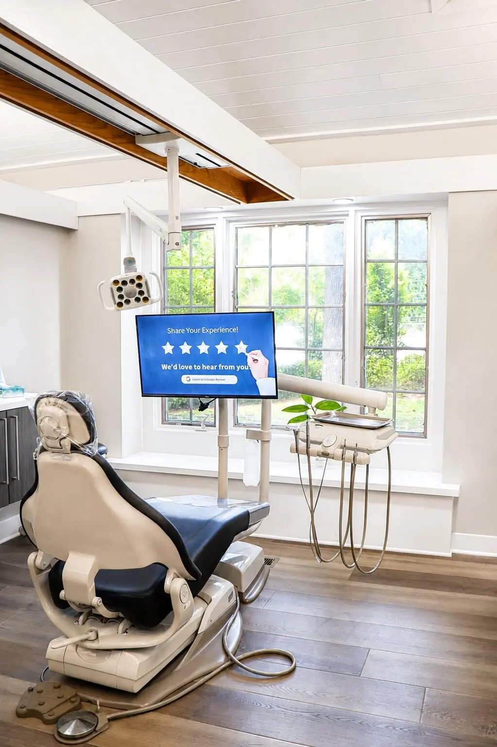 Modern dental treatment room at ProGrin Dental of Anderson with an overhead exam light and a mounted patient television